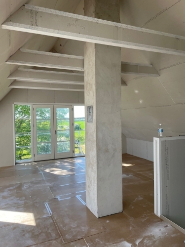 Indvendig tilbygning til hus med loft til kip, store vinduer og nyt rum